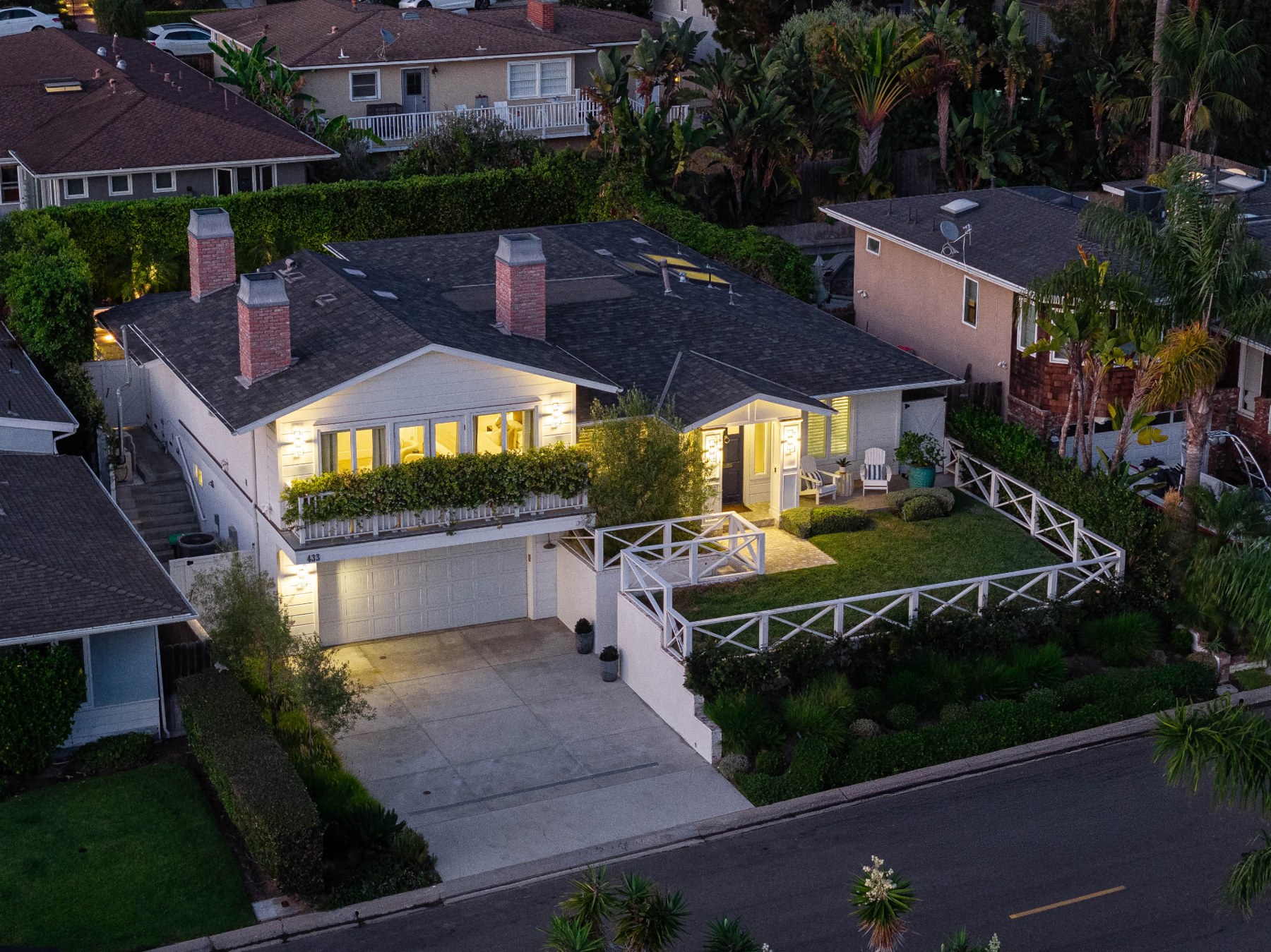 Elevated front view of 433 Seaward Road showing the driveway, garage, porch and landscaped garden
