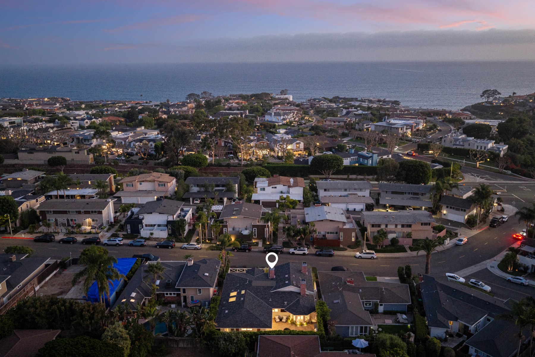 Elevated view of 433 Seaward Road and surrounding Corona del Mar homes, with the ocean on the horizon
