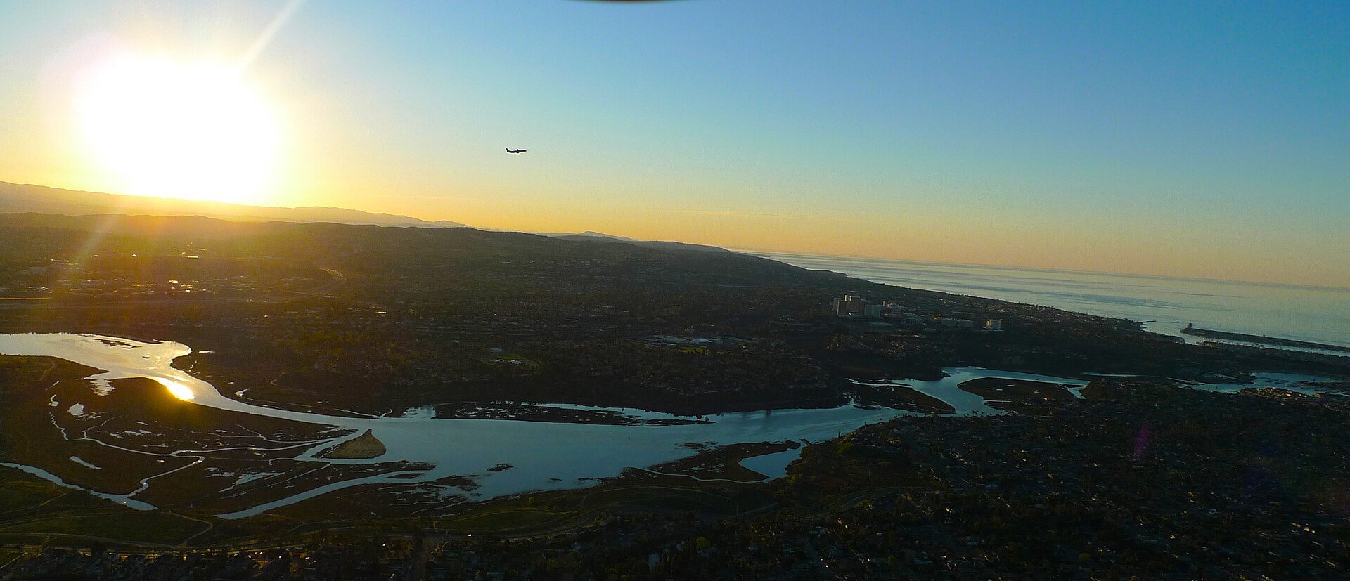 Aerial view of Newport Beach luxury waterfront homes, the Balboa Peninsula and Newport Harbor at sunrise — Mr_Newport, Michael Mena, Douglas Elliman